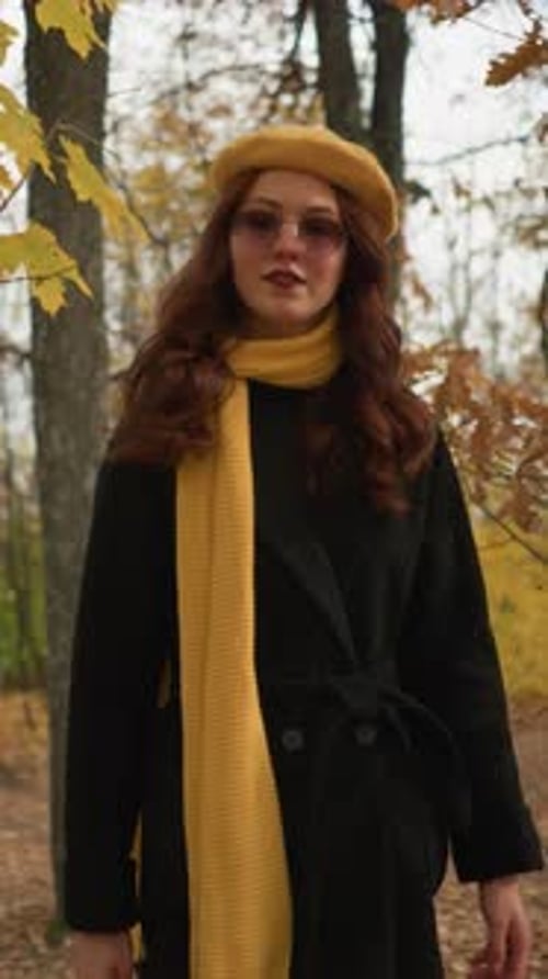 Stylish Lady in Autumn Attire Walking Forest Path