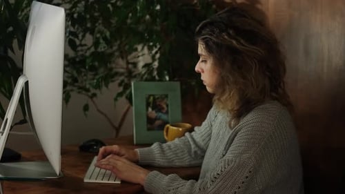 Young Woman Takes Online Exam Using Computer