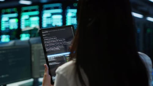 Close Up of Woman Doing Maintenance in Server Room Using Tablet