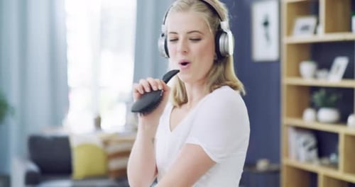Woman Singing and Dancing with Hairbrush in Home