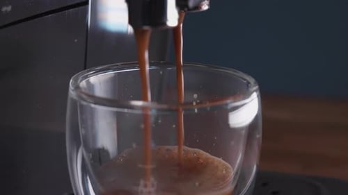 Fresh Coffee Pouring into a Glass Cup