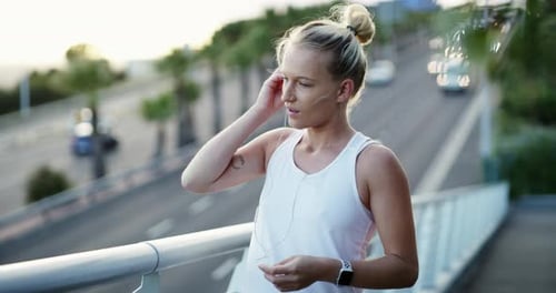 Earphones, fitness and young woman in city preparing for cardio race, competition