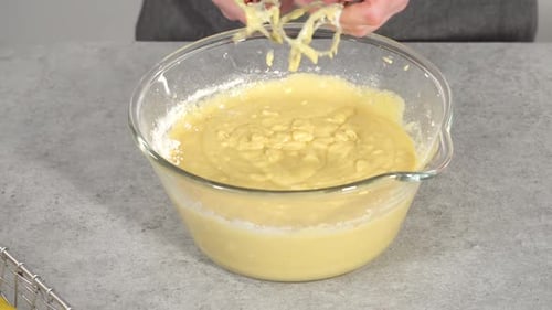 Step By Step Mixing Ingredients in a Glass Mixing Bowl to Prepare Lemon Cranberry Bundt Cake
