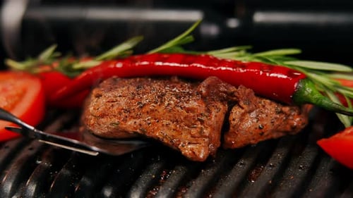 Juicy Steak on a Grill with Fresh Vegetables
