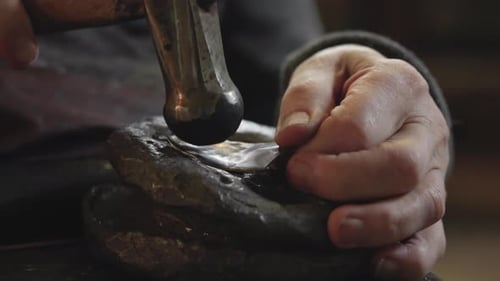 Senior Elderly Master Jeweler in Wheelchair Works in a Workshop