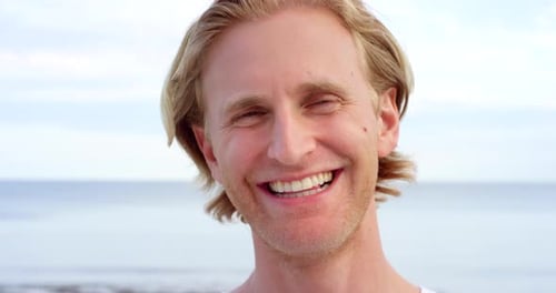 Smiling Blond Man on Beach Ocean Background