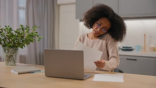 Woman Working at Desk, Talking on Phone