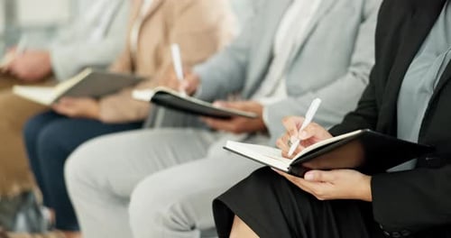 Audience Taking Notes at a Meeting