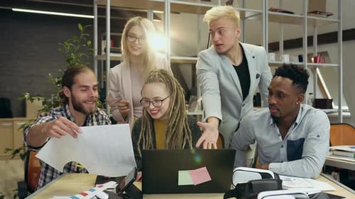 Multiethnic man and woman start-up team working at joint business project in contemporary office.