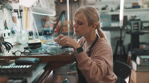 Woman Jeweler Working on Jewelry in Studio