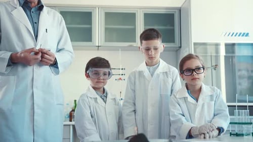 Children Conduct Science Experiment in Bright Laboratory