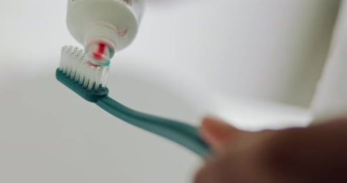 Toothpaste hands on toothbrush, morning oral hygiene and clean teeth, wellness