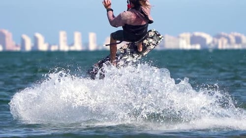 Sportsman practicing kite surf sport at the beach on a windy day at the Spanish coasts