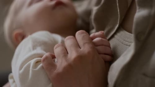 Close Up of Infant Sleeping Peacefully in Arms