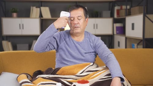 Adult Man Checking Temperature at Home