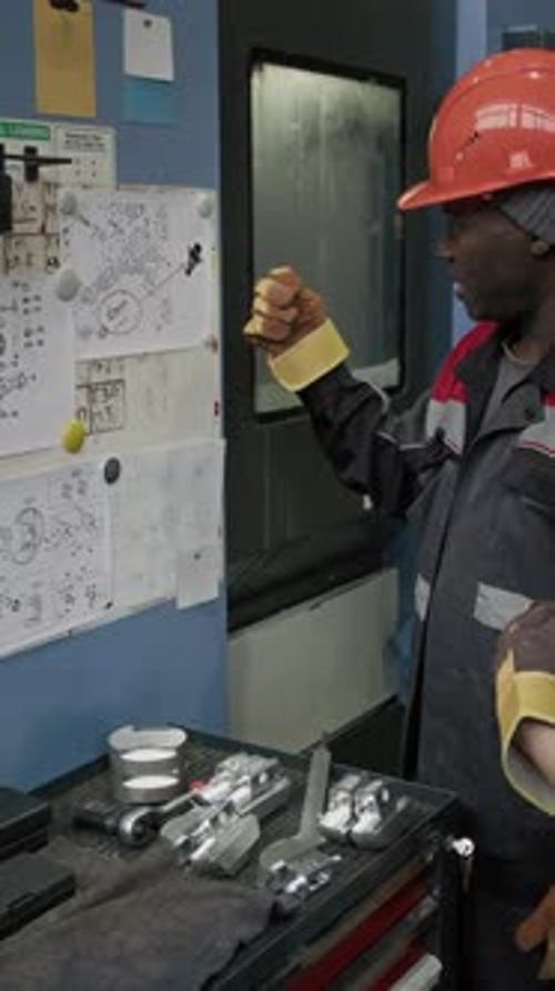 Vertical of Foreman Explaining Blueprint to Workwoman