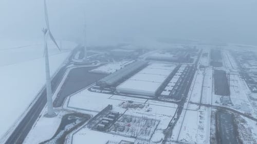 Wind turbines powering data center in winter snow