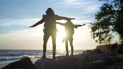 Enjoy Freedom in Touristic Trip Back View of Two Backpackers Standing on Stones Happy People