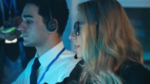 Callcenter-Frau mit Headset arbeitet spät in einem Technikbüro
