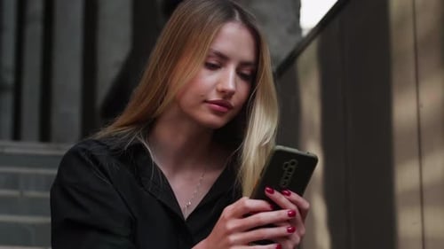 Woman Reacting Positively to Smartphone Message