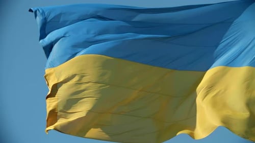 Ukraine Flag Waving Against Blue Sky