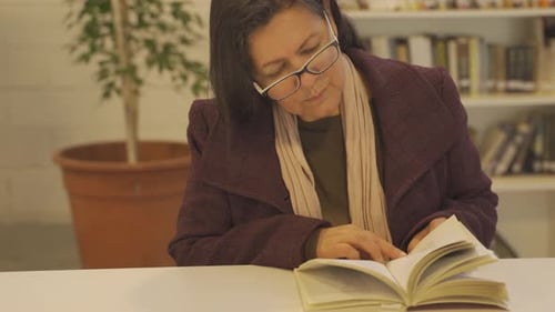 Senior argentinian reading literature books at library