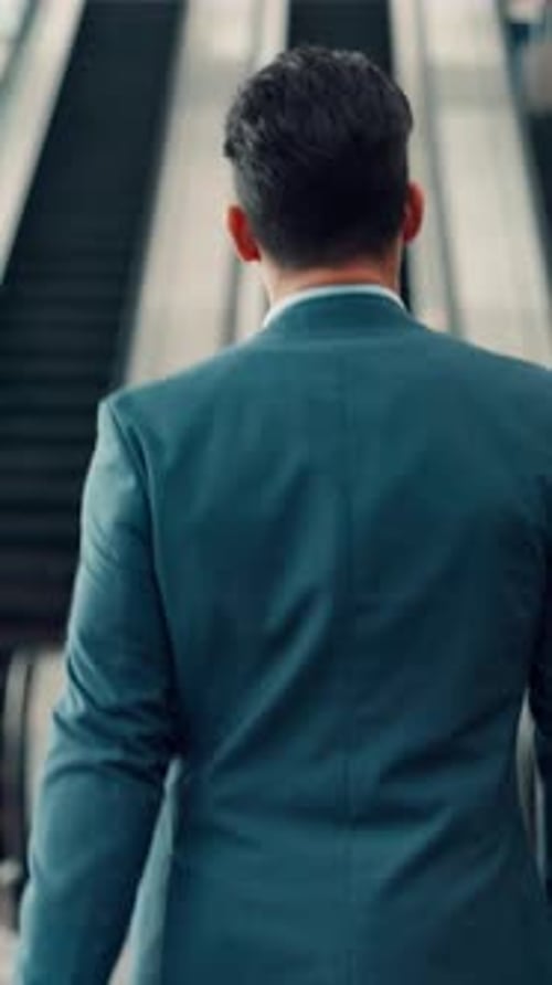 Behind, escalator and man walking with luggage in airport for international business trip or travel