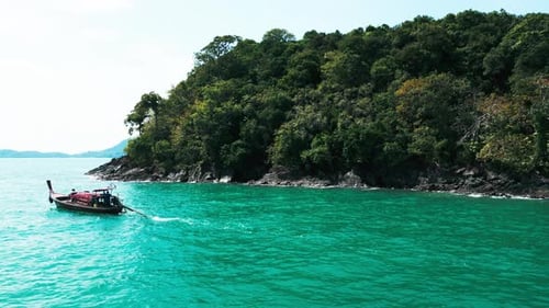 Aerial View of a Motorboat in a Tropical Paradise with Coastal Cliffs
