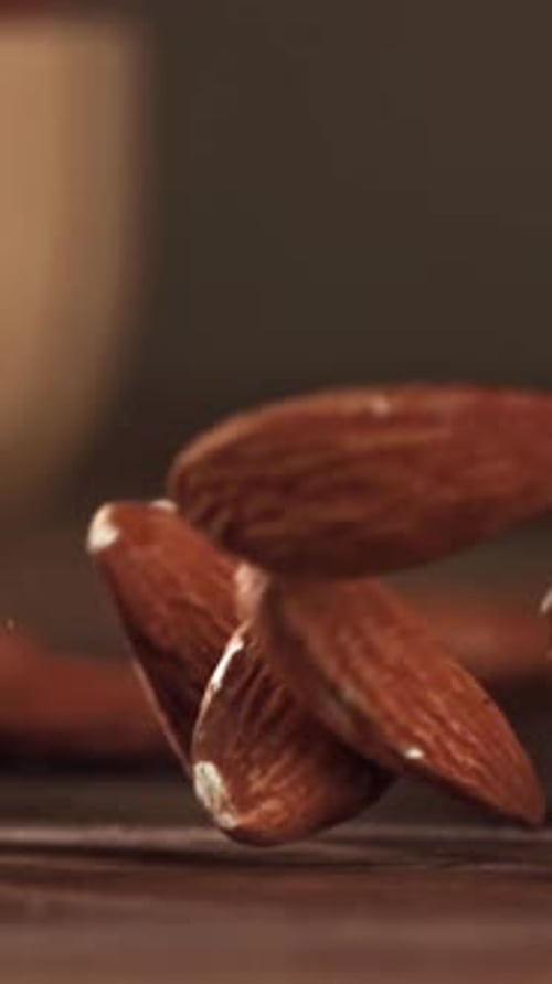 Almonds Fall on a Wooden Table Filmed on a Highspeed Camera at 1000 Fps