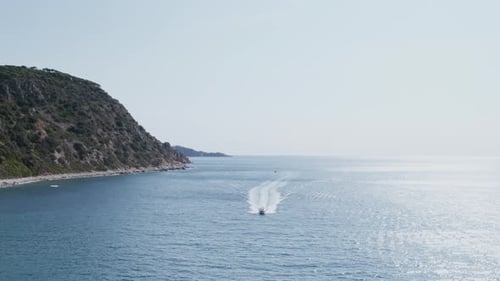 Drone Shot of Motorboat Sail Into Bay or Cove