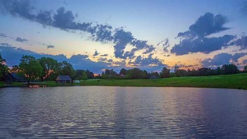 Time lapse of cloudy sunset with reflection in the river on an Island