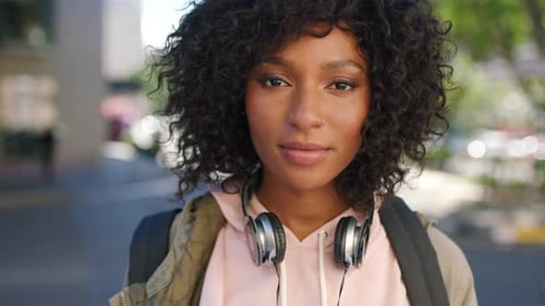 Portrait of a trendy young black woman with a carefree and cool attitude standing in the city
