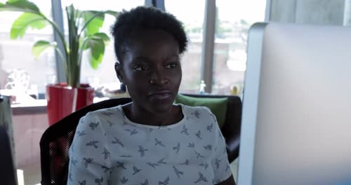 Focused Businesswoman Working at Computer at Office Desk African Ethnicity