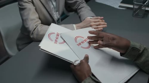 Tense Workplace Meeting with Classified Documents