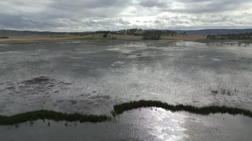 Aerial view of a wetland during sunset with beautiful natural hills landscape in the background