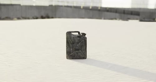 Abandoned Jerry Can Rests on the Sand Beneath a Bright Sky View