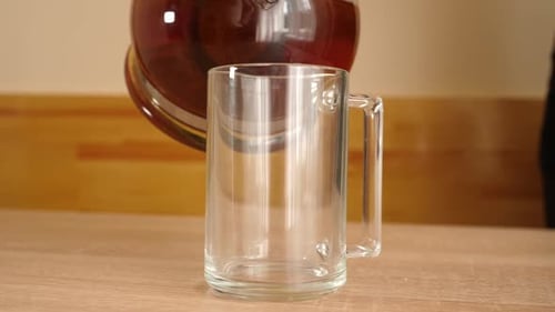 Pouring Tea Into a Glass Mug