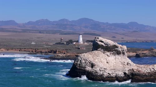 Breathtaking Scenic Coastal View Featuring a Lighthouse Alongside a Rocky Shoreline