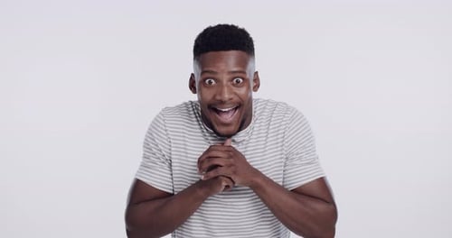 Man, face and excited surprise in studio or good news announcement, secret or accomplishment