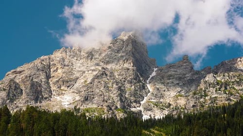 Majestic Mountain Range Under Cloudy Blue Skies