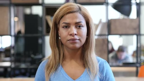 Young Woman Looking Directly at Camera in Office
