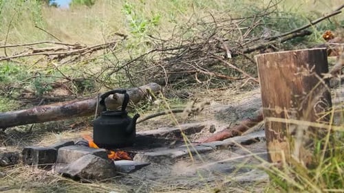 Old Kettle Standing on a Tourist Campfire in Nature