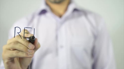 Hand Writes the Word Reliability with a Marker