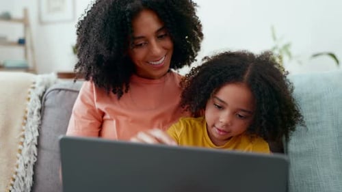 Mother and Child Using Laptop Together at Home