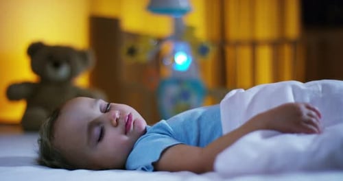 sleeping baby happy and carefree, the mother caresses kiss goodnight. concept of house and home.