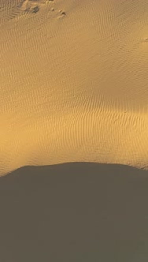Sand Dune in Desert Drone is Flying to the Right at High Altitude Aerial Ve Vertical Video