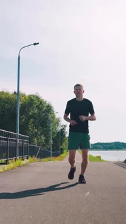 Morning Jog By the Lake Embracing Fitness and Nature Runner Jogging in the Morning Young Man Morning
