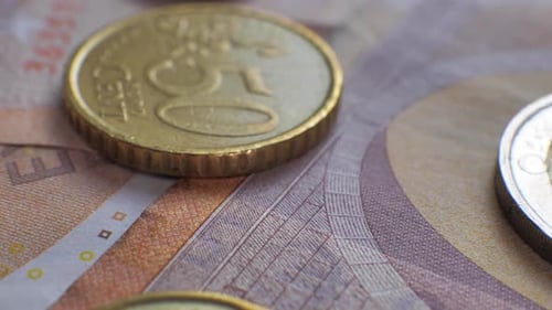 Macro Shot of Euro Coins on Fifty Euro Bill