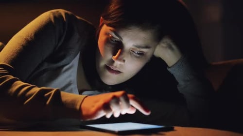 4k video footage of a woman using a digital tablet at home