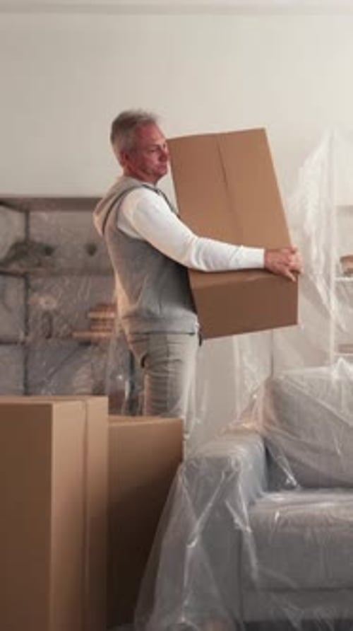 Couple Moving in With Boxes and Plastic Covers